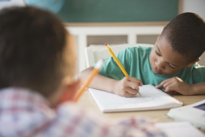 Image of boy journalling in Kindergarten