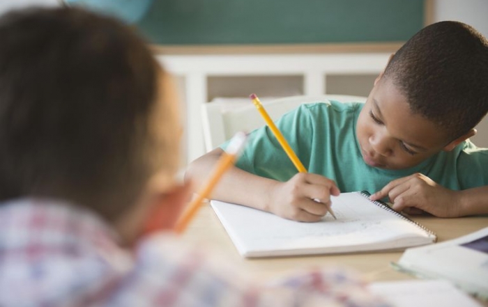 Image of boy journalling in Kindergarten