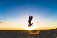 Photo Credit: Amamath Tade and Unsplash (image of woman in joy jumping in the air on beach)